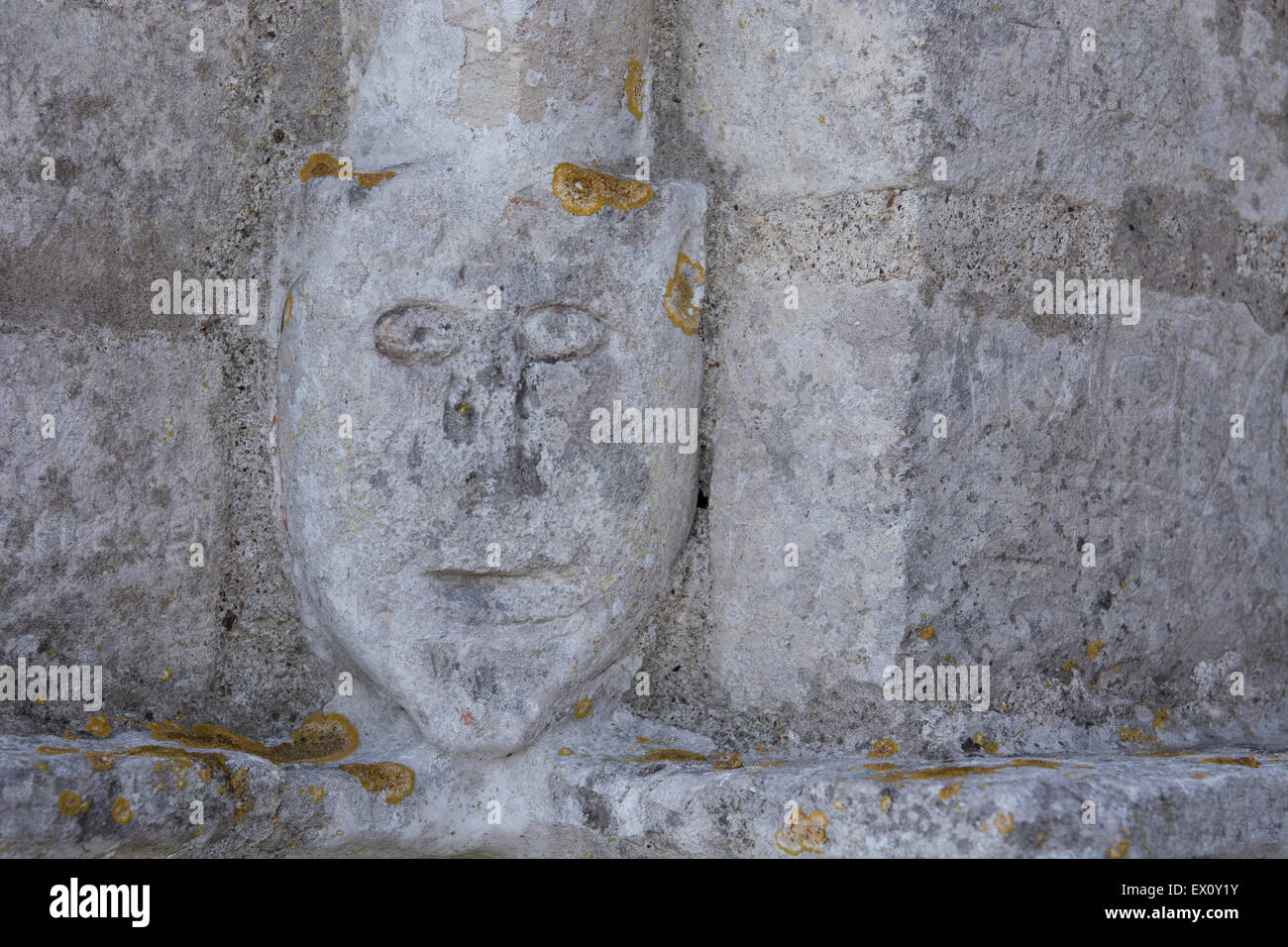 A gargoyle effigy face sculpture on the wall of the old church of Højerup in Denmark Stock Photo