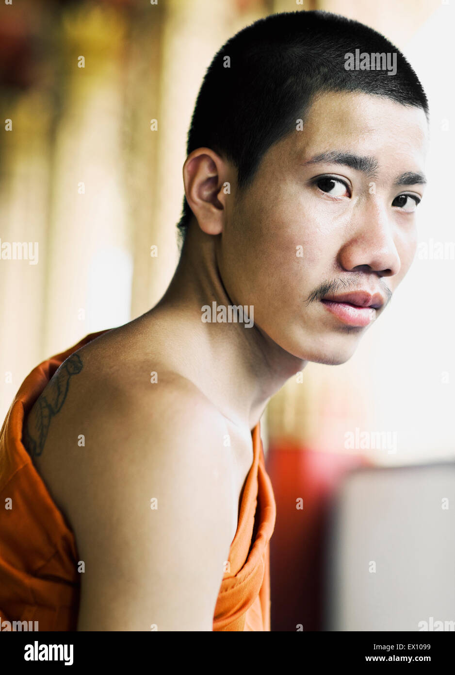 A portrait of a  19-year-old  monk at Wat Manoran. Luang Prabang, Laos Stock Photo