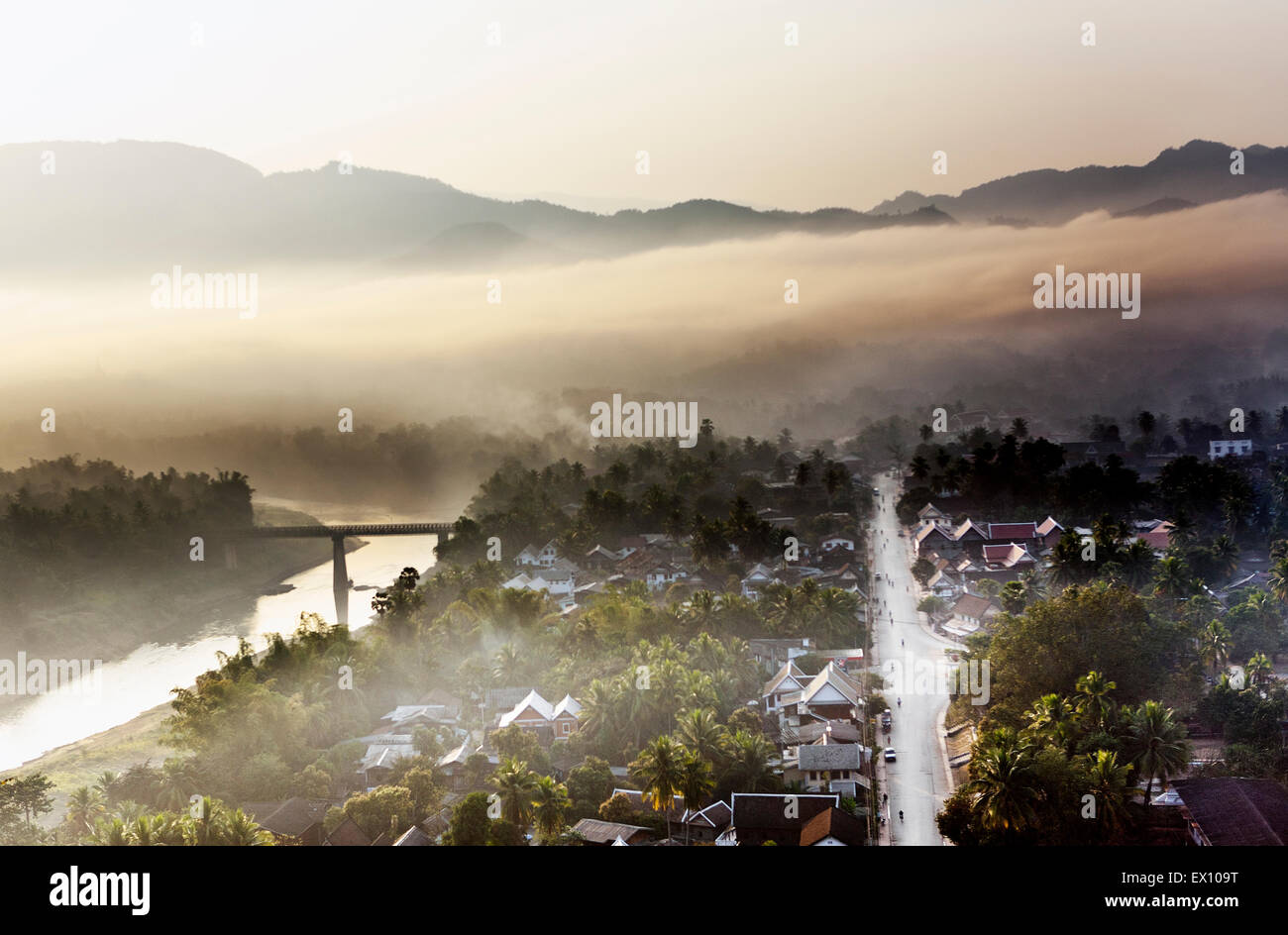 Luang Prabang at sunrise from the top of Mt. Phou Si. In the Lao language, “Phou” means mountain and “Si” means hermit. Stock Photo
