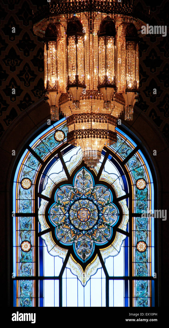 Stained glass window and crystal chandelier, Sultan Qaboos Grand Mosque, Muscat, Oman Stock Photo