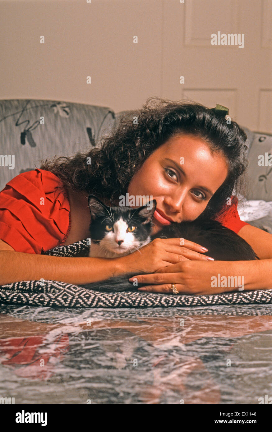 Young Latin-American woman cuddling male kitten Stock Photo