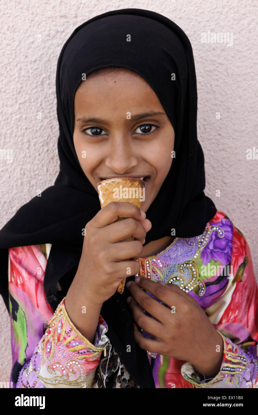 Muslim girl eating ice cream, Nizwa, Sultanate of Oman Stock Photo