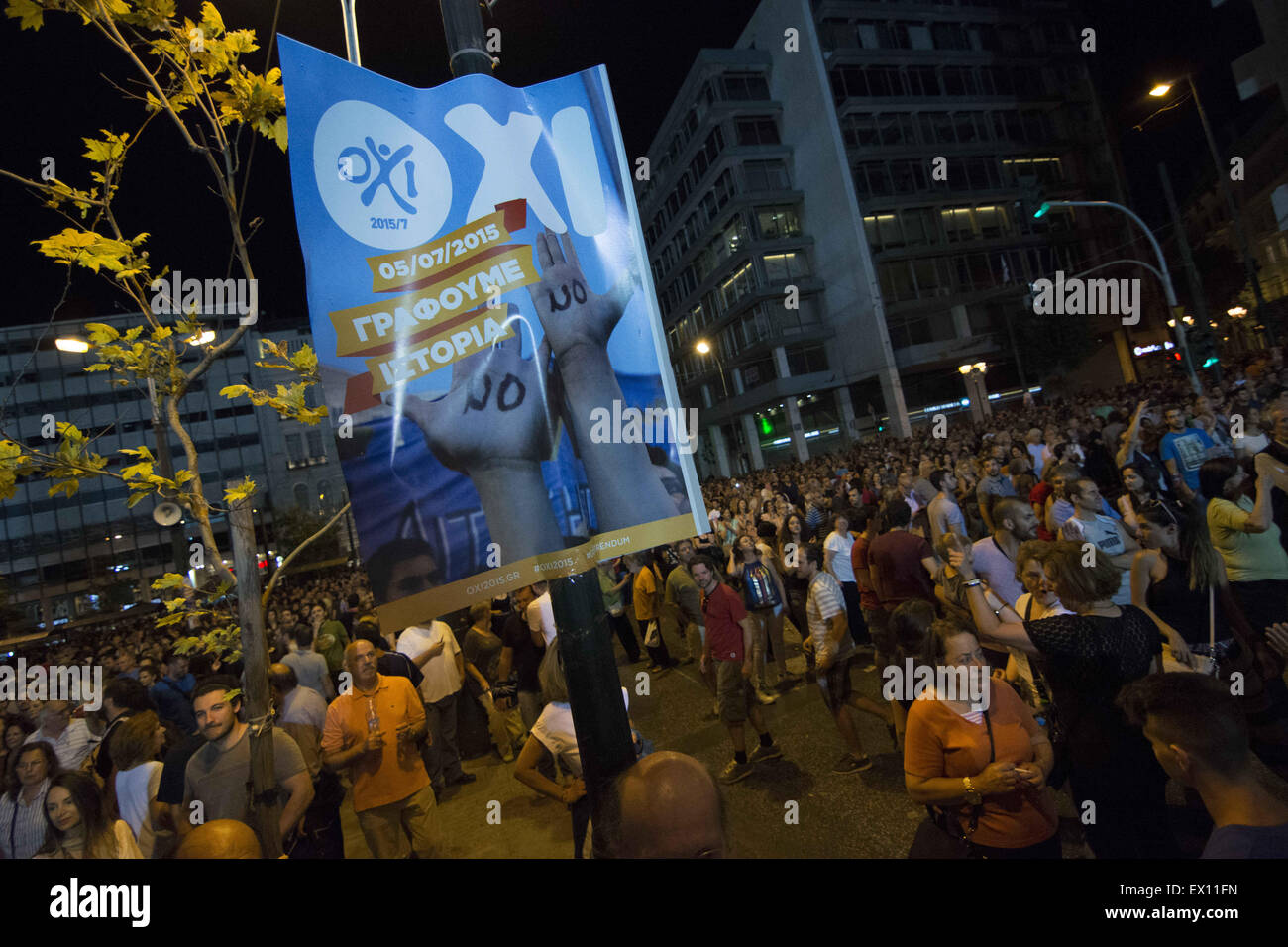 Athens, Greece. 3rd July, 2015. People with OXI(No) stickers shout slogans against the bailout deal. More than two hundred thousand people, according to estimates, gathered at Syntagma Square in front of the Greek parliament to protest in favor of a No vote, on the upcoming referendum where citizens will get to decide whether they agree or not to the bailout deal offered by the Institutions(ECB, IMF, EU) and the austerity measures that come with it. © Nikolas Georgiou/ZUMA Wire/ZUMAPRESS.com/Alamy Live News Stock Photo
