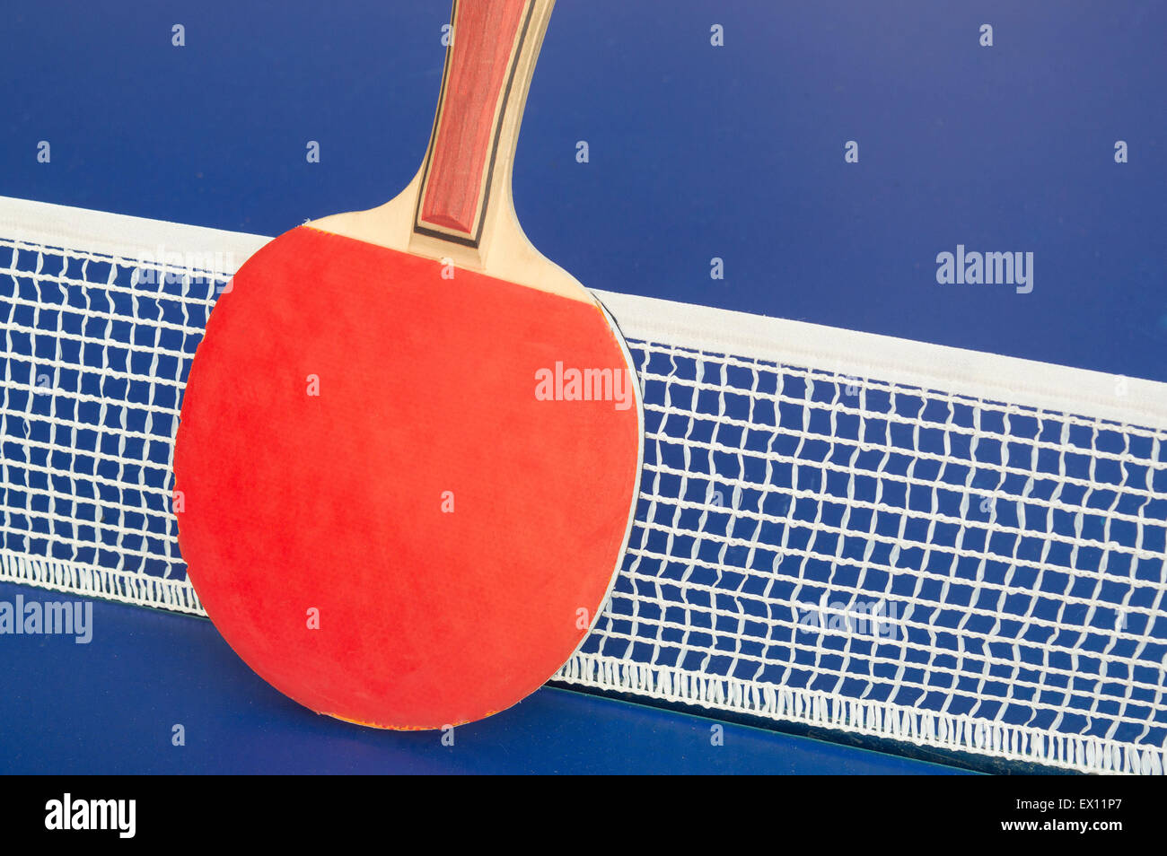Table tennis paddle and net on a table Stock Photo
