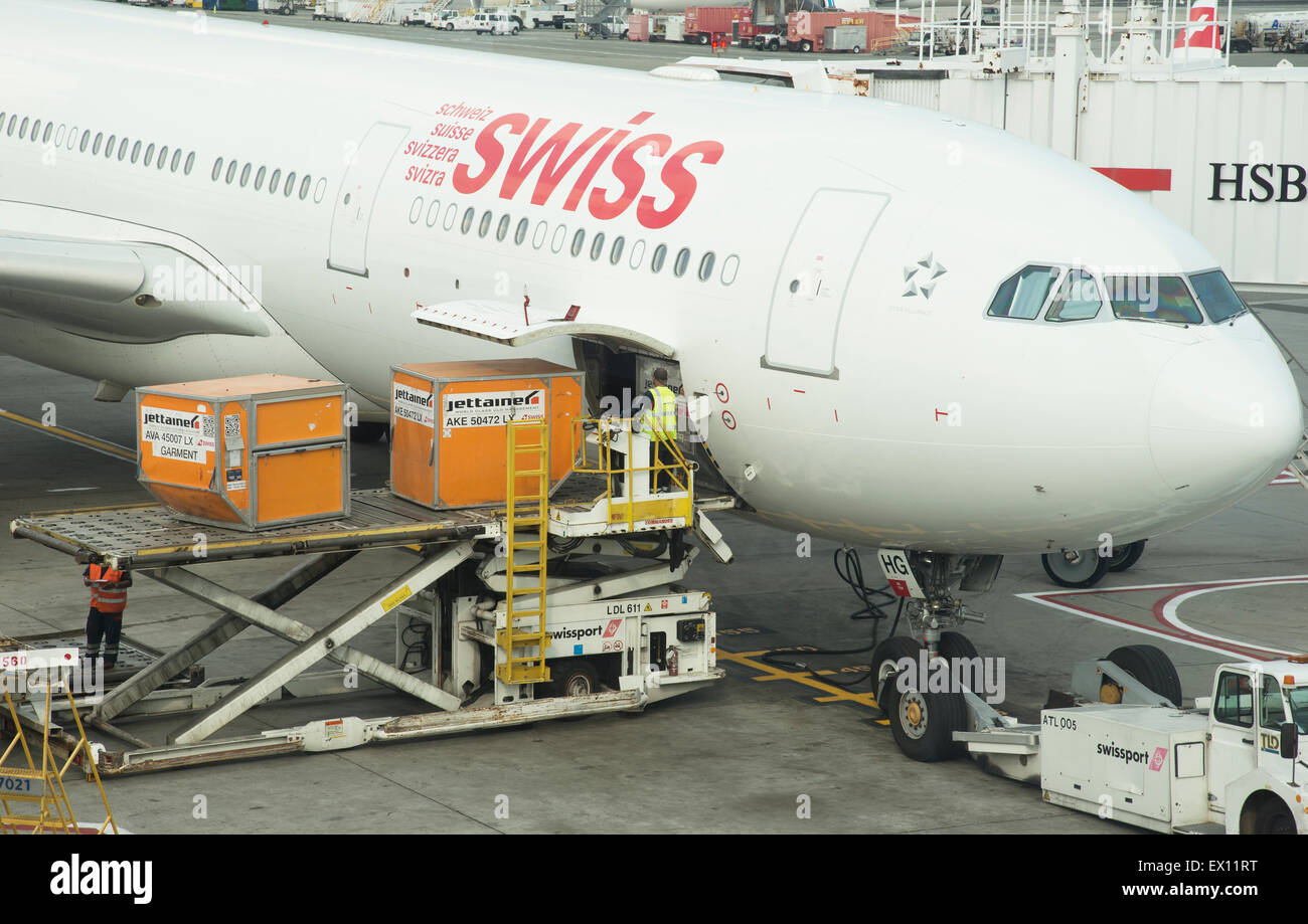 Cargo handling Containers being stowed in the hold of a Swiss Airbus A330 aircraft at JFK USA Stock Photo