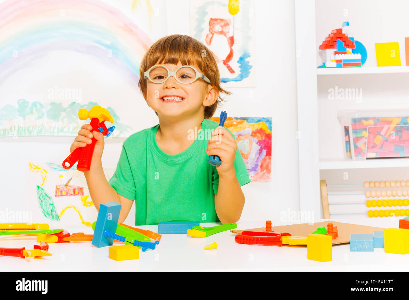 Smart boy in glasses with toy work tools Stock Photo