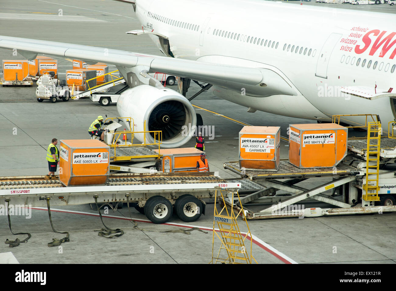 Cargo handling Containers being stowed in the hold of a Swiss Airbus A330 aircraft at JFK USA Stock Photo