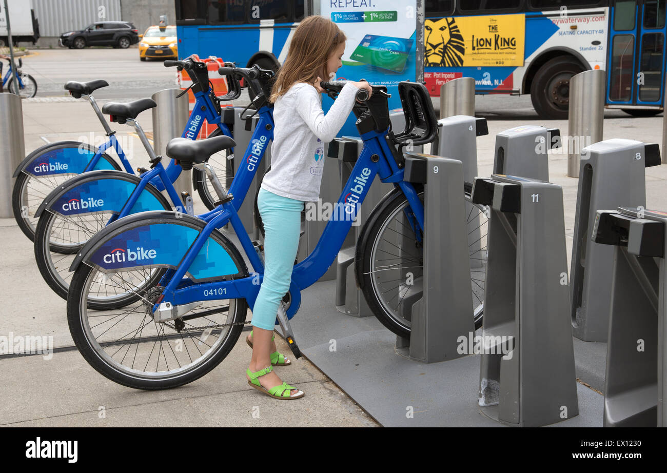 Bicycle rental station in New York USA . Child using the Citibike
