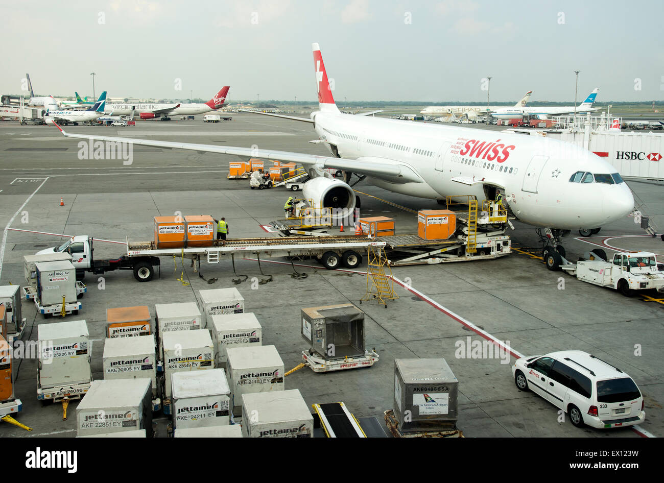 Cargo handling Containers being stowed in the hold of a Swiss Airbus A330 aircraft at JFK USA Stock Photo