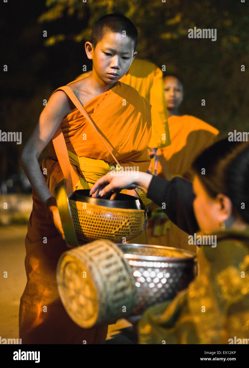 Monk processing for alms in the early morning, a 1,000-year old tradition in Luang Prabang, Laos. Stock Photo