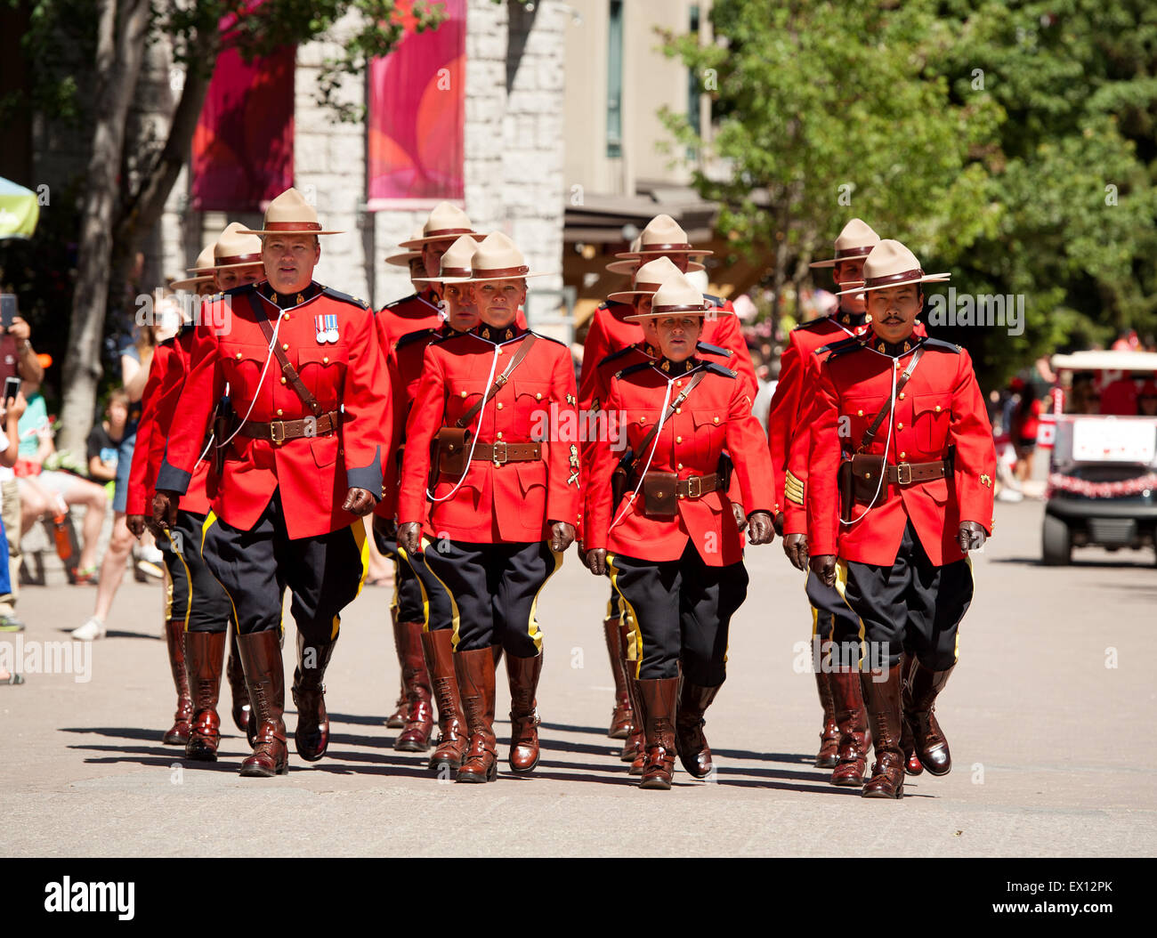 Royal Canadian Mounted Police officers parade in ceremonial red serge uniforms for Canada Day.  Canadian Police, or RCMP Stock Photo