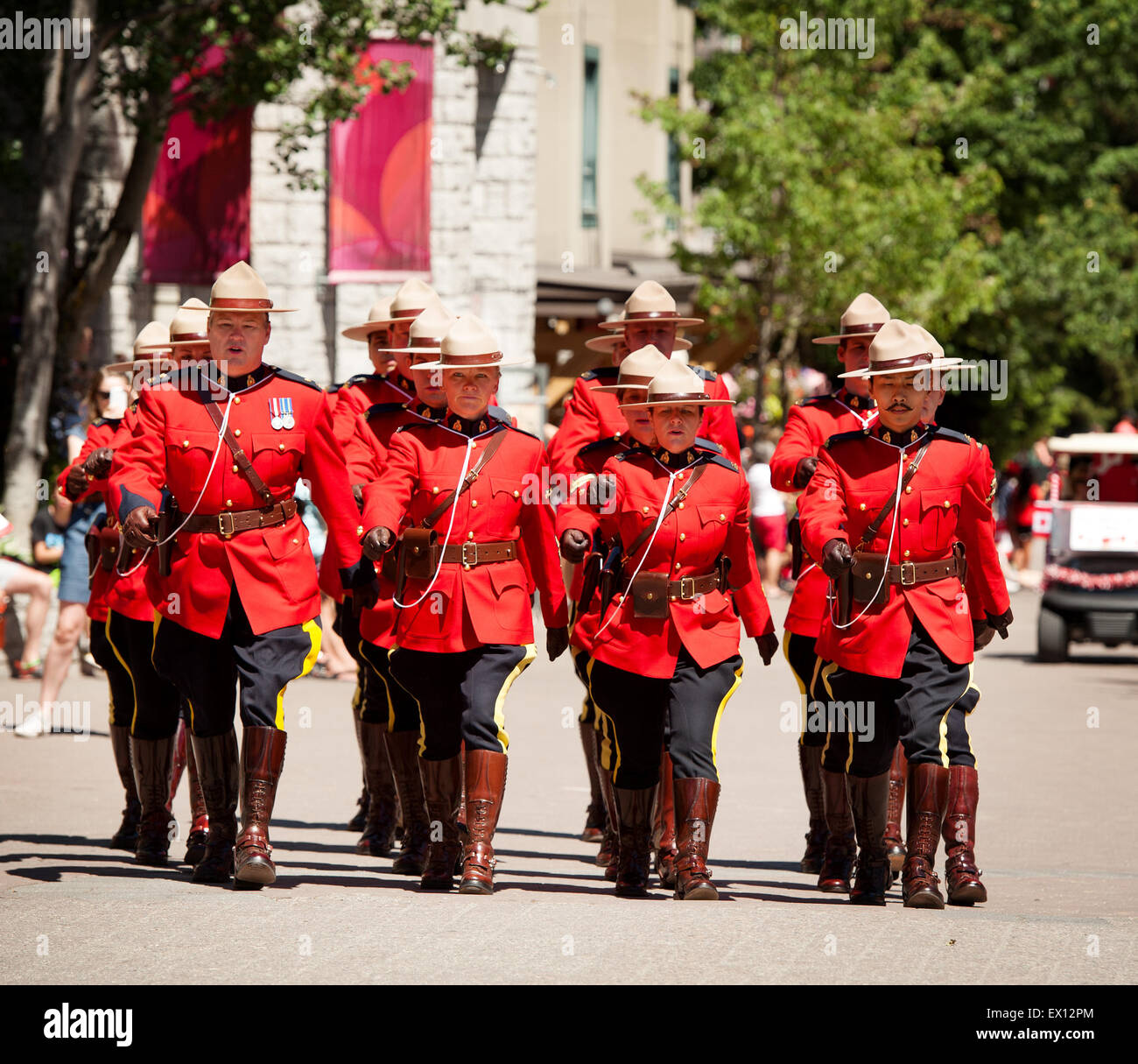 Royal Canadian Mounted Police officers parade in ceremonial red serge uniforms for Canada Day.  Canadian Police, or RCMP Stock Photo