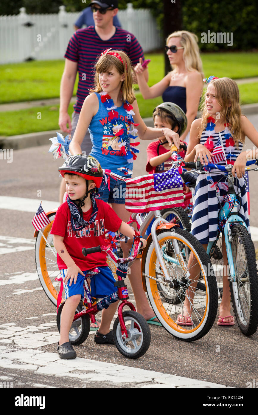 A group of children on their bicycles decorated with American flags during the Daniel Island Independence Day parade July 3, 2015 in Charleston, South Carolina. Stock Photo