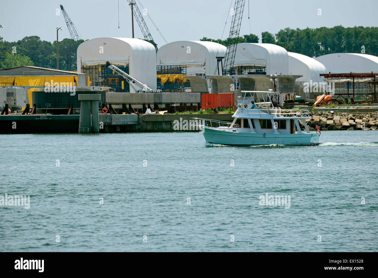 A small powerboat travels along the waterfront in Cape Charles