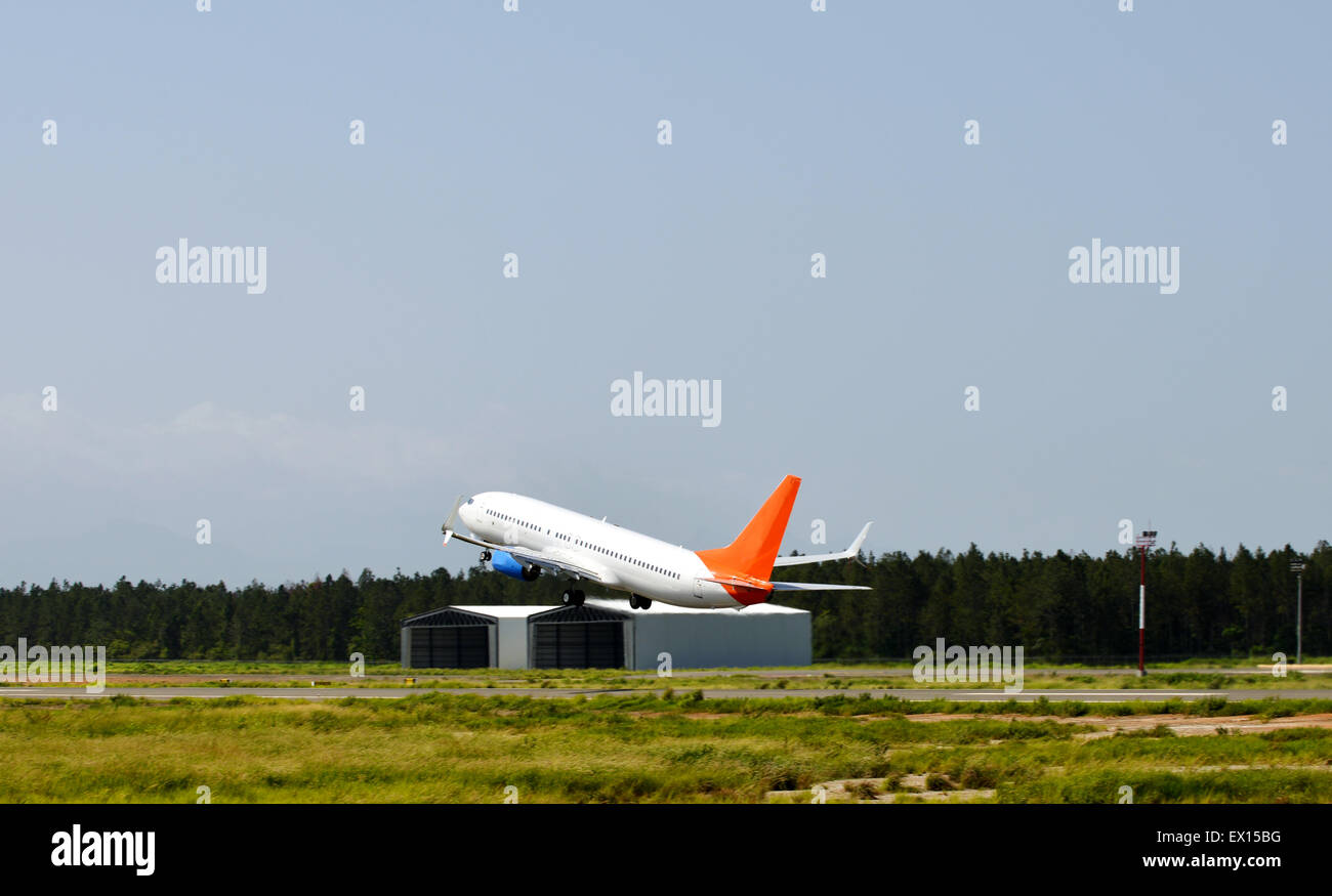 Airliner taking off from an airport runway Stock Photo