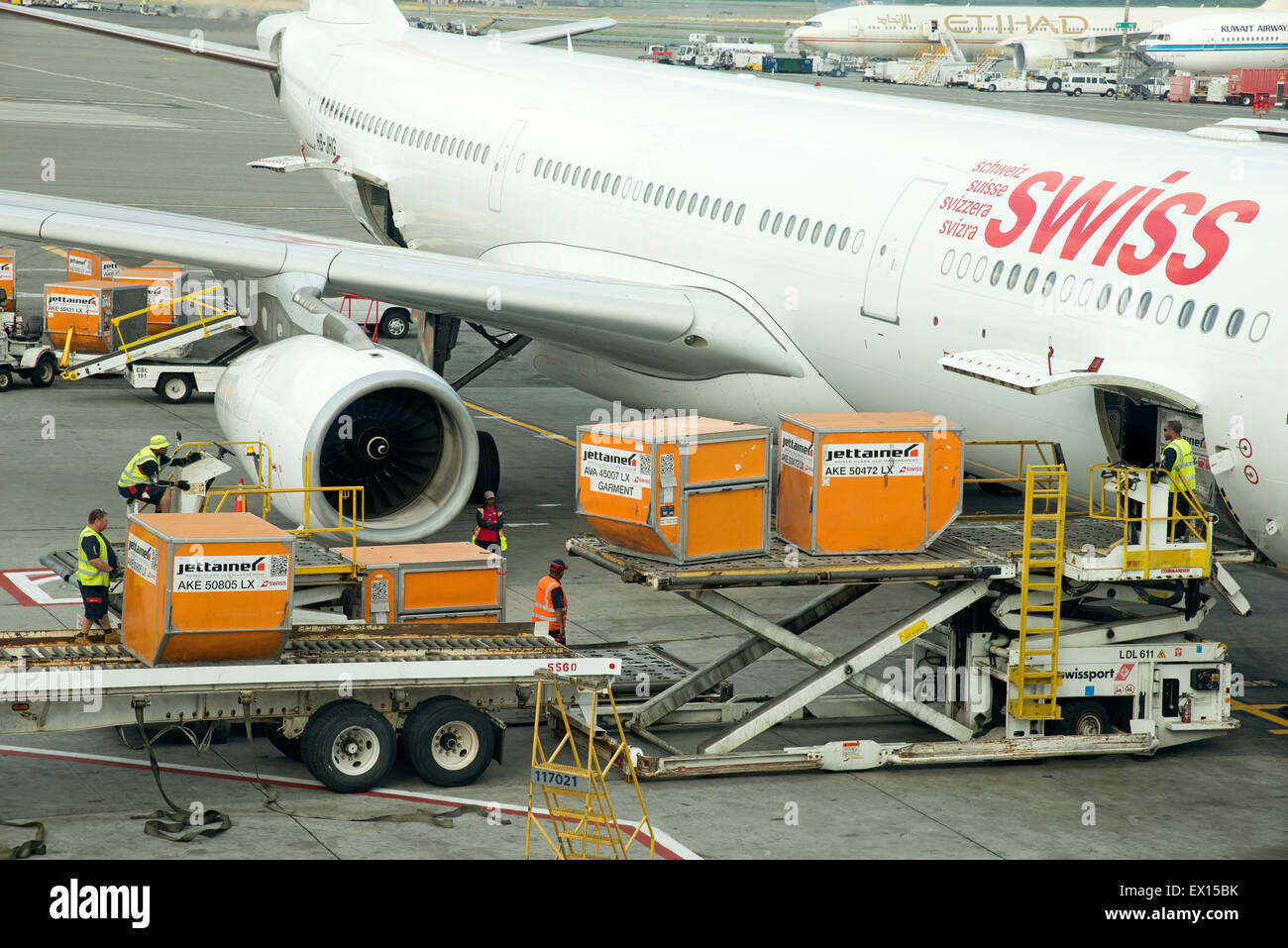 Cargo handling Containers being stowed in the hold of a Swiss Airbus A330 aircraft at JFK USA Stock Photo