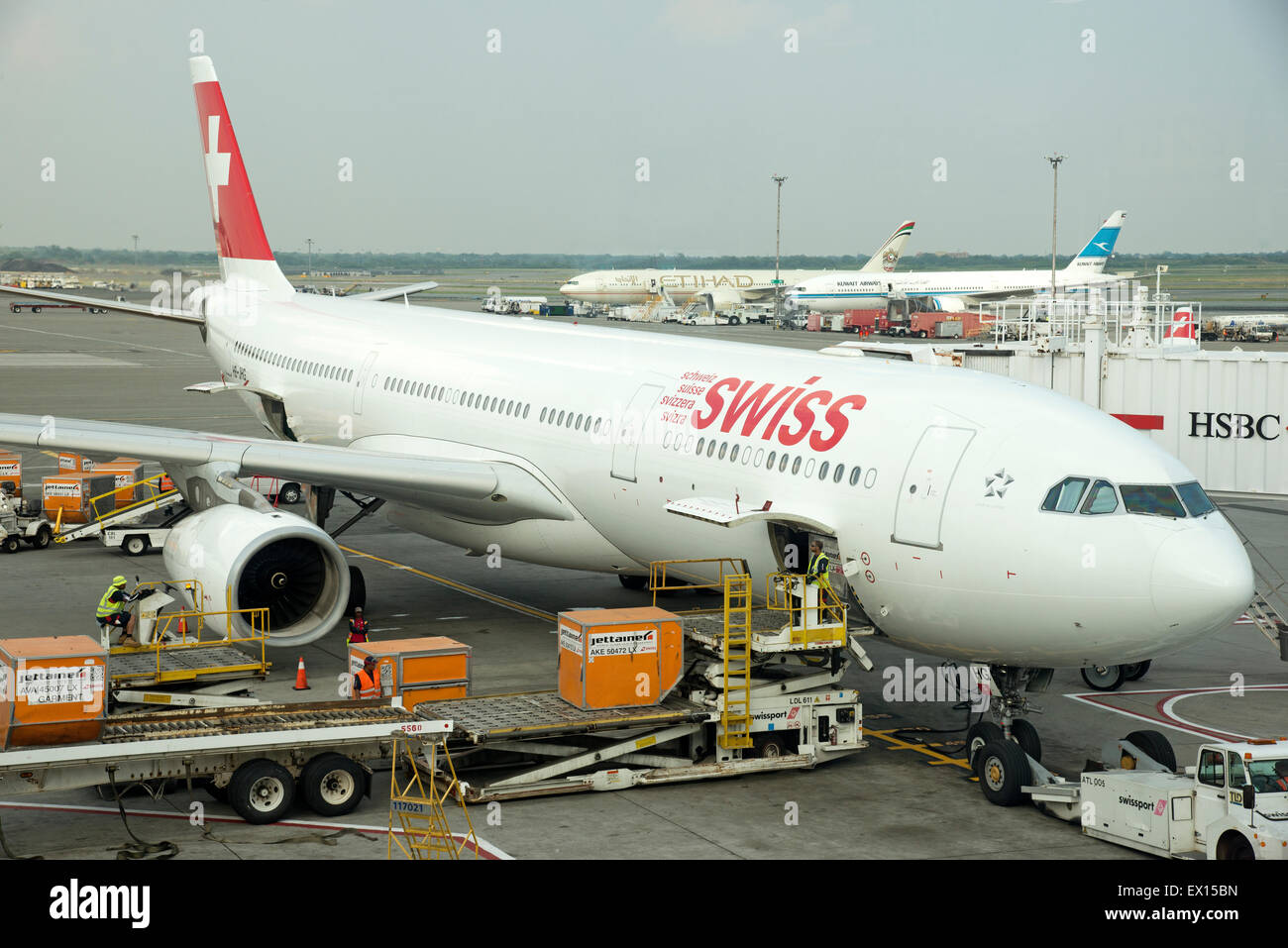 Cargo handling Containers being stowed in the hold of a Swiss Airbus A330 aircraft at JFK USA Stock Photo
