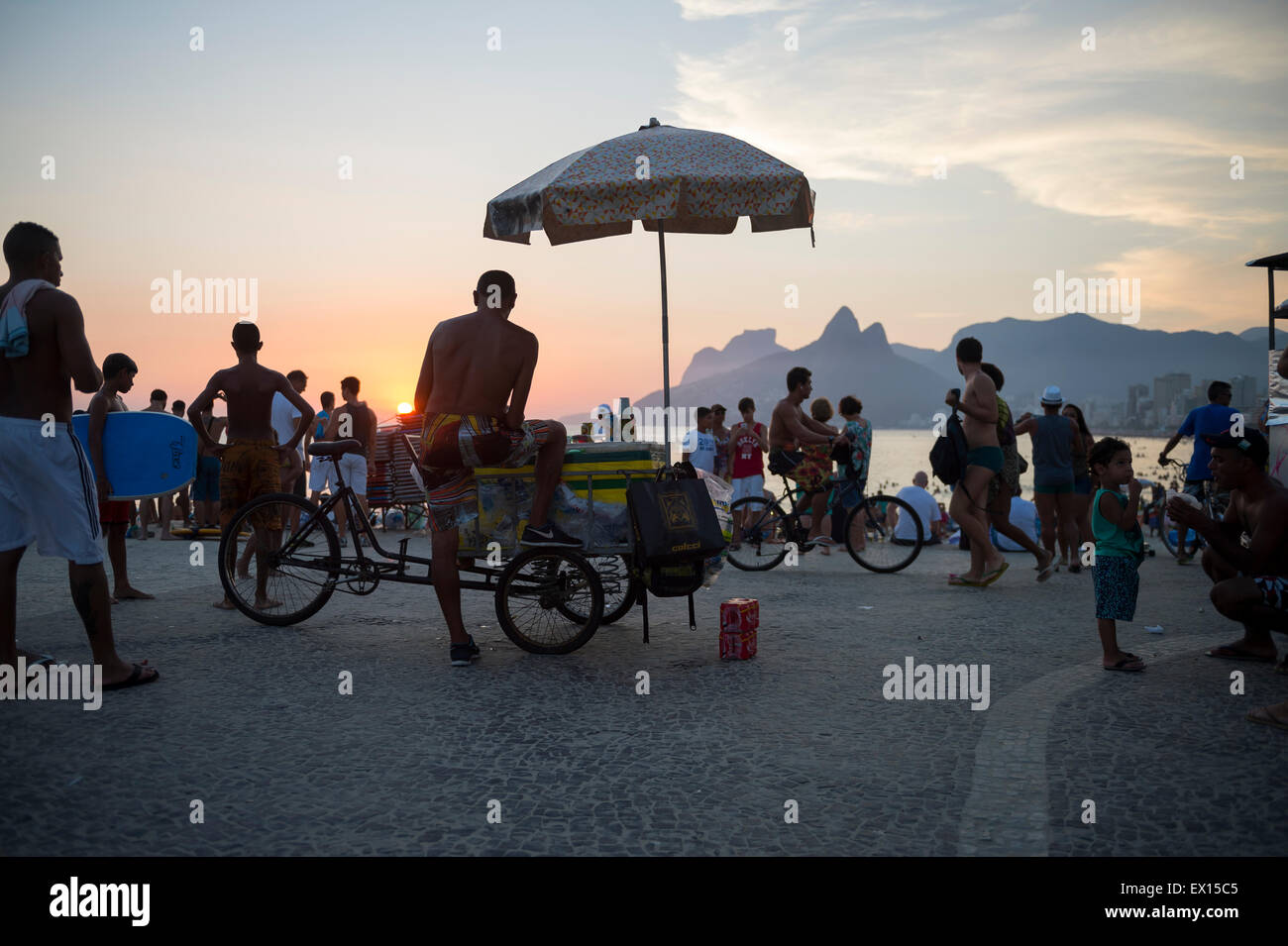 RIO DE JANEIRO, BRAZIL - FEBRUARY 21, 2015: Vendors and tourists gather at Arpoador for the daily sunset watching ritual. Stock Photo