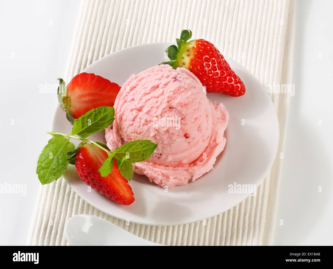 Scoop of ice cream with fresh strawberries Stock Photo