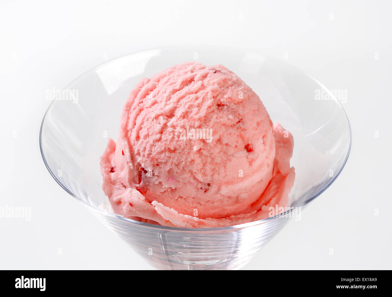 Scoop of strawberry ice cream  in stemmed glass Stock Photo