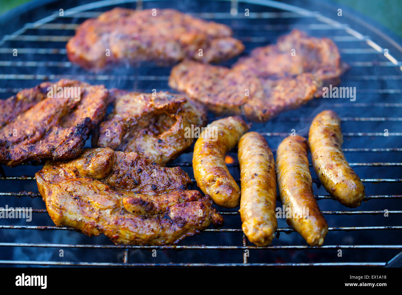 Sausages and meat on bbq Stock Photo