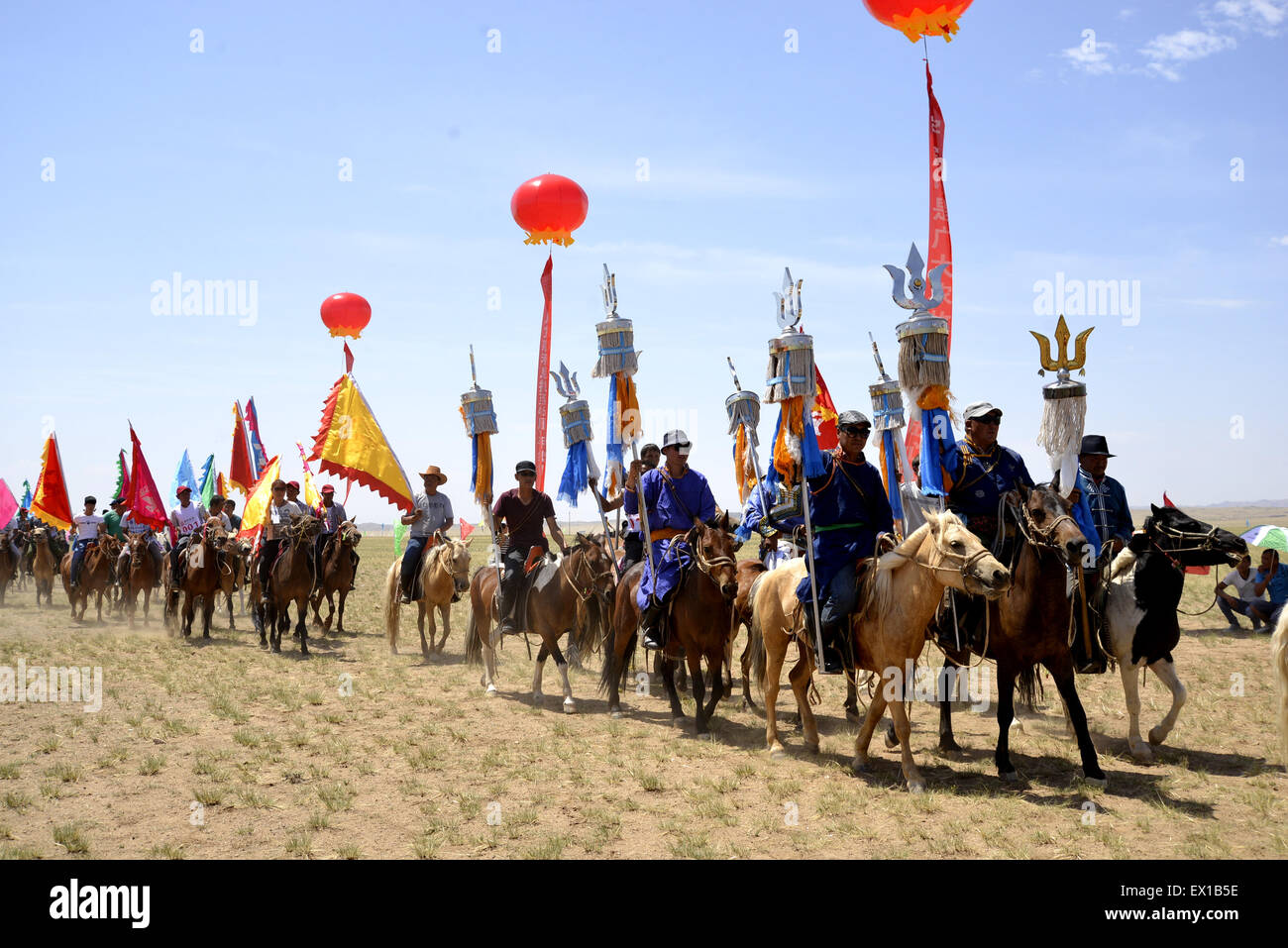 Bayan Nur, China's Inner Mongolia Autonomous Region. 4th July, 2015. People attend a Nadam fair in Urat Middle Banner, north China's Inner Mongolia Autonomous Region, July 4, 2015. Nadam is a mass traditional Mongolian festival where people celebrate harvests and pray for good luck. Credit:  Zhi Maosheng/Xinhua/Alamy Live News Stock Photo