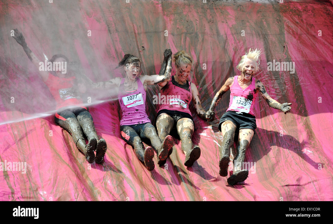 Brighton UK Saturday 4th July 2015 - Thousands of women take part in the Cancer Research UK Race for Life Pretty Muddy event held in Stanmer Park Brighton today . They had to take part in a 5k obstacle course finishing with a slide into a large pit of mud Credit:  Simon Dack/Alamy Live News Stock Photo