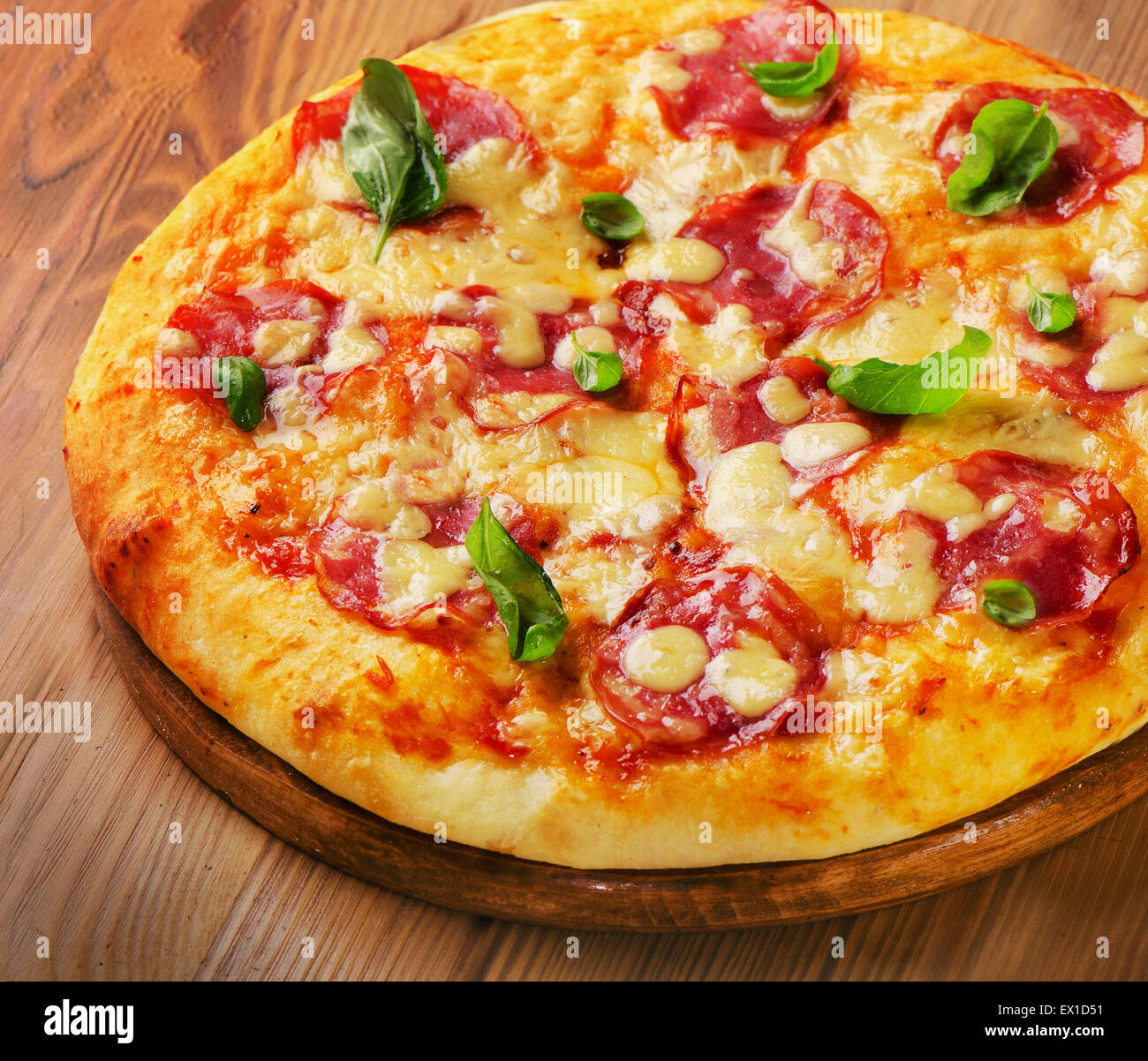 Homemade salami pizza on  wooden  board. Selective focus Stock Photo