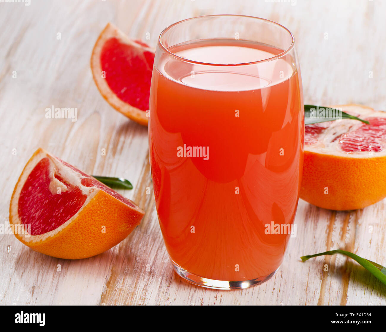 Fresh grapefruit juice  on a white wooden table. Selective focus Stock Photo