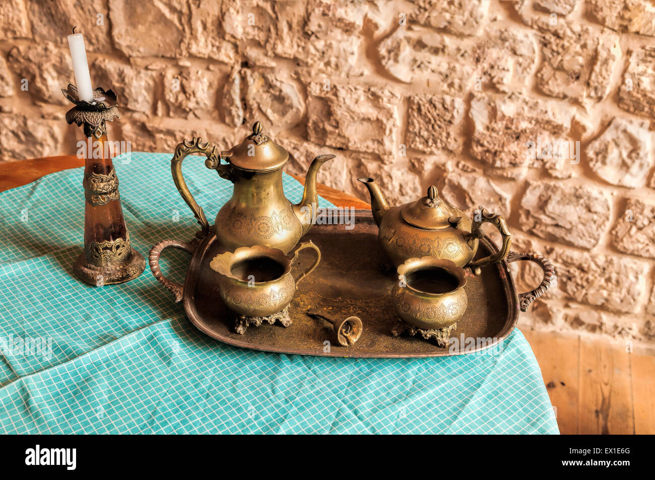 Dinner set of dishes for coffee and tea from the old bronze bell on the tray with the call for workers Stock Photo