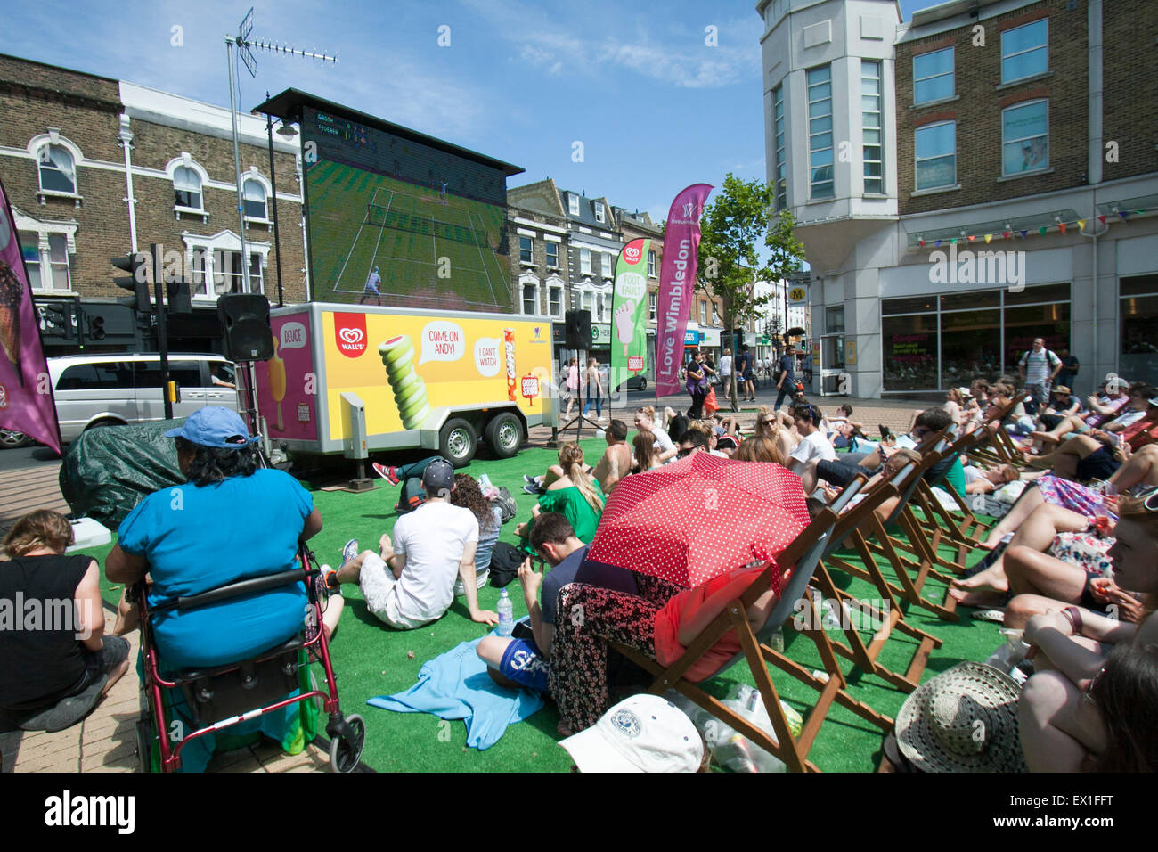 Wimbledon, London, UK. 04th July, 2015. People watch a live tennis match between Roger Federer and Sam Groth on big screens in Wimbledon town centre Credit:  amer ghazzal/Alamy Live News Stock Photo
