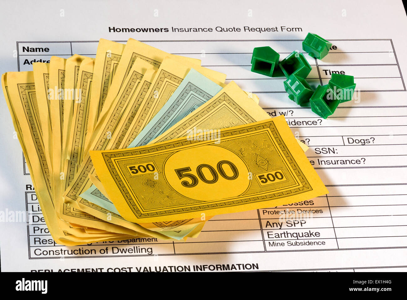 Home insurance quote form with play money and houses Stock Photo