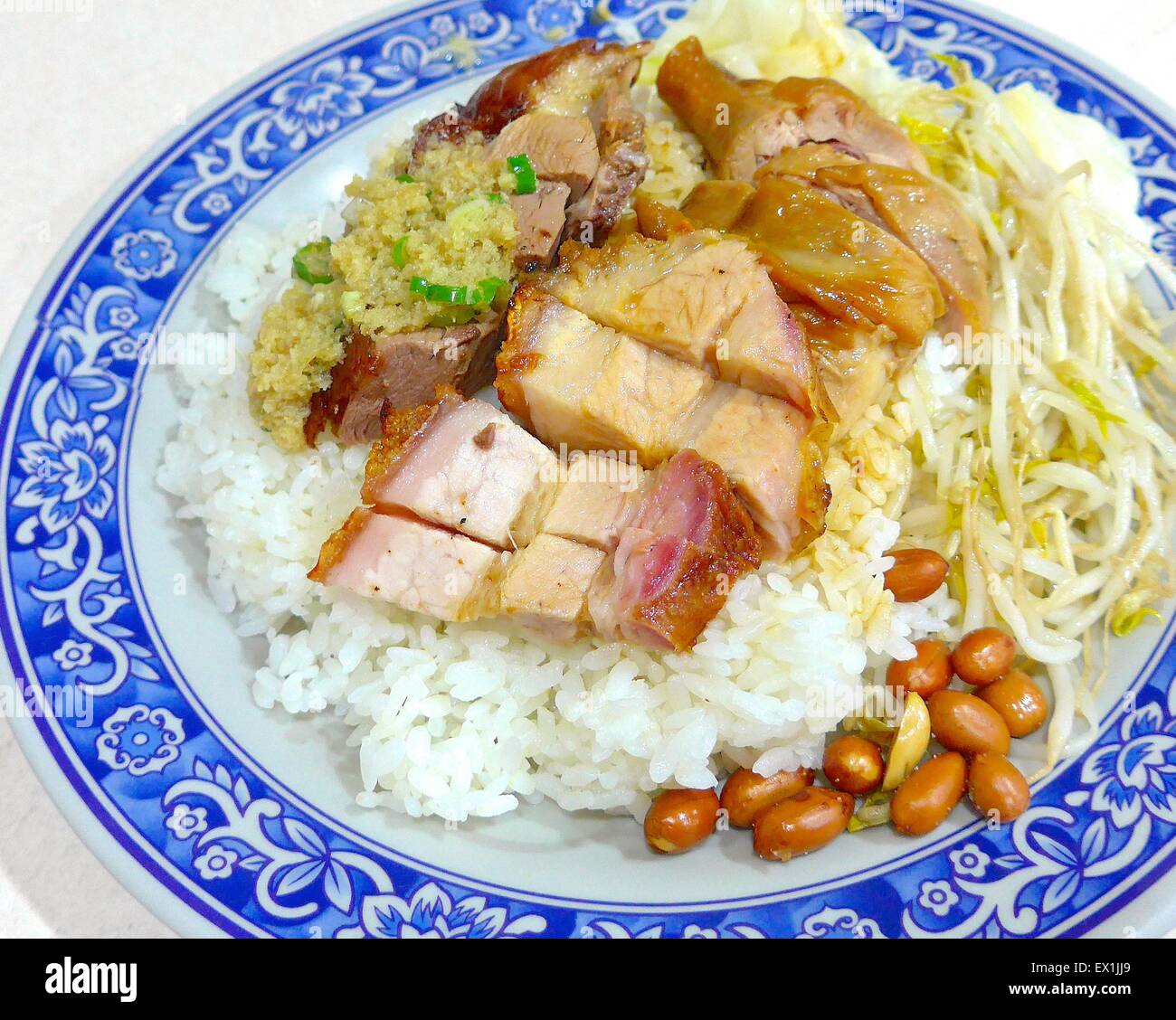 Combination of soy sauce chicken, roast duck and BBQ pork on rice in