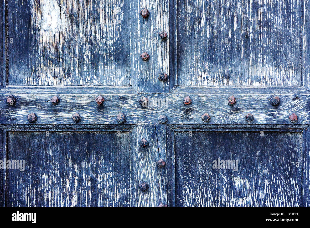 Close up view of a section of an old worn wooden studded door. Stock Photo