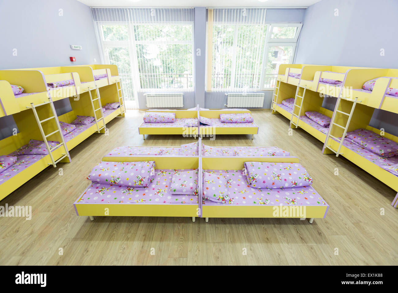 Modern kindergarten bedroom with small bunk beds with stairs for the