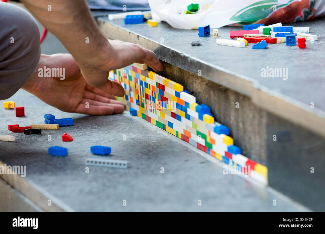 Sofia, Bulgaria - June 6, 2015: The artist Jan Vormann is filling the cracks in the exterior of a building in Sofia with Lego bl Stock Photo