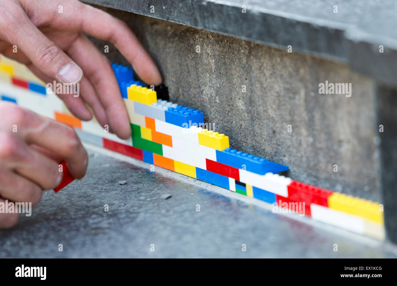 Sofia, Bulgaria - June 6, 2015: The artist Jan Vormann is filling the  cracks in the exterior of a building in Sofia with Lego bl Stock Photo -  Alamy