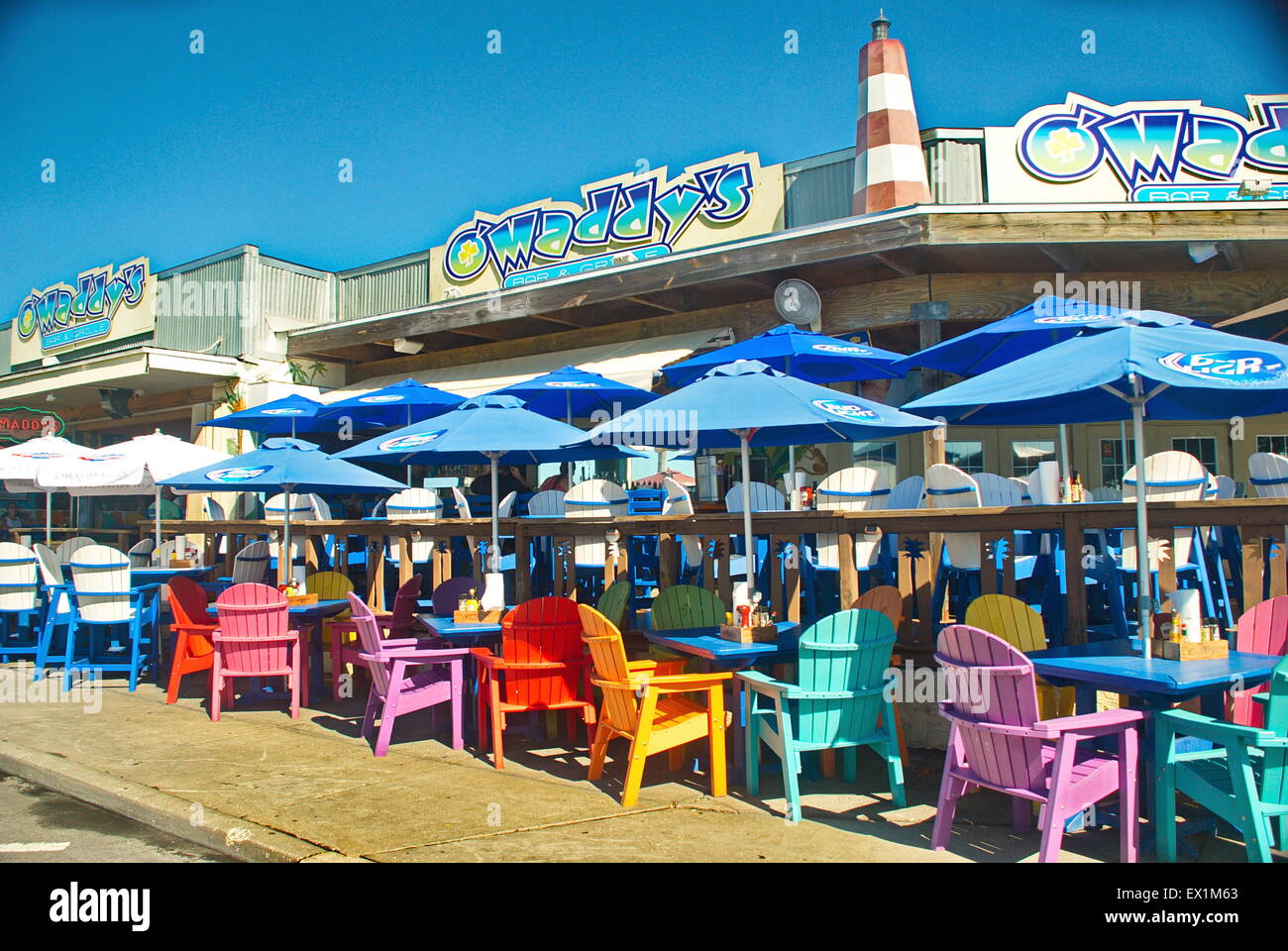 Bright colorful adirondak chairs at beach seafood restaurant in Florida. Stock Photo