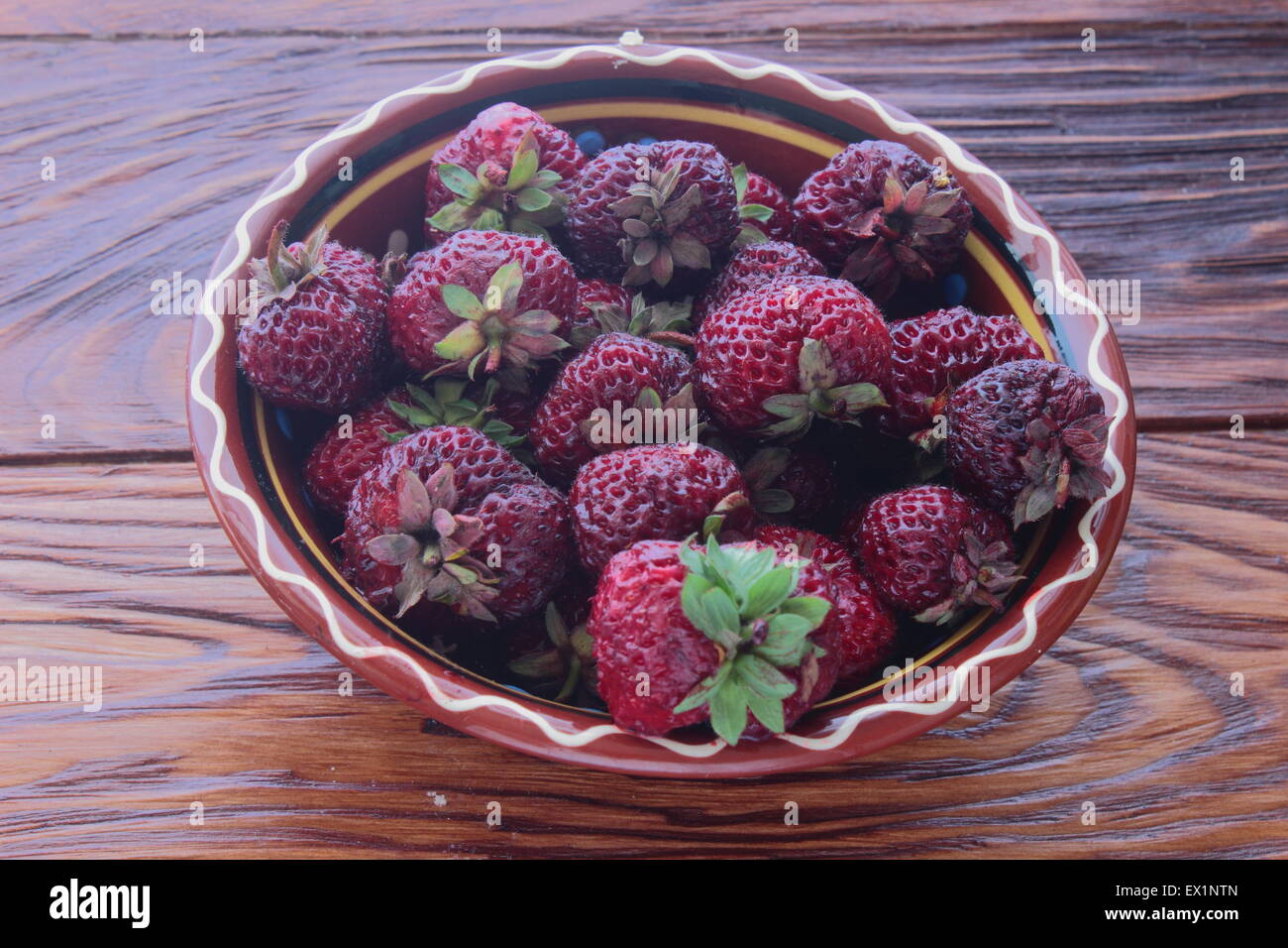the plate is a sweet dark red strawberries Stock Photo - Alamy