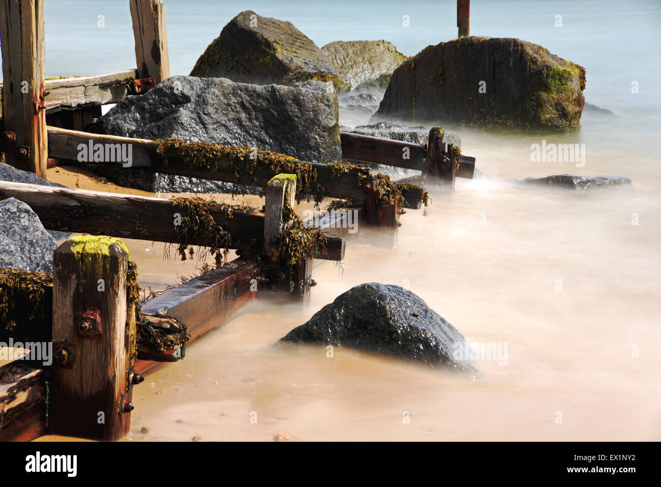 The sea with groyne and rocks utilising a 10 stop light loss filter. Stock Photo