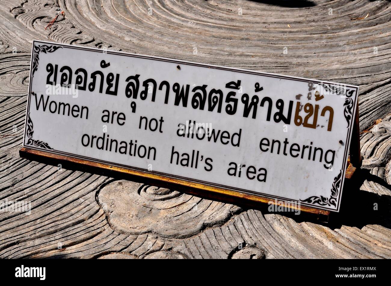 Chiang Mai, Thailand: Sign in Thai and English advises that women are not permitted to enter the ordination hall Stock Photo