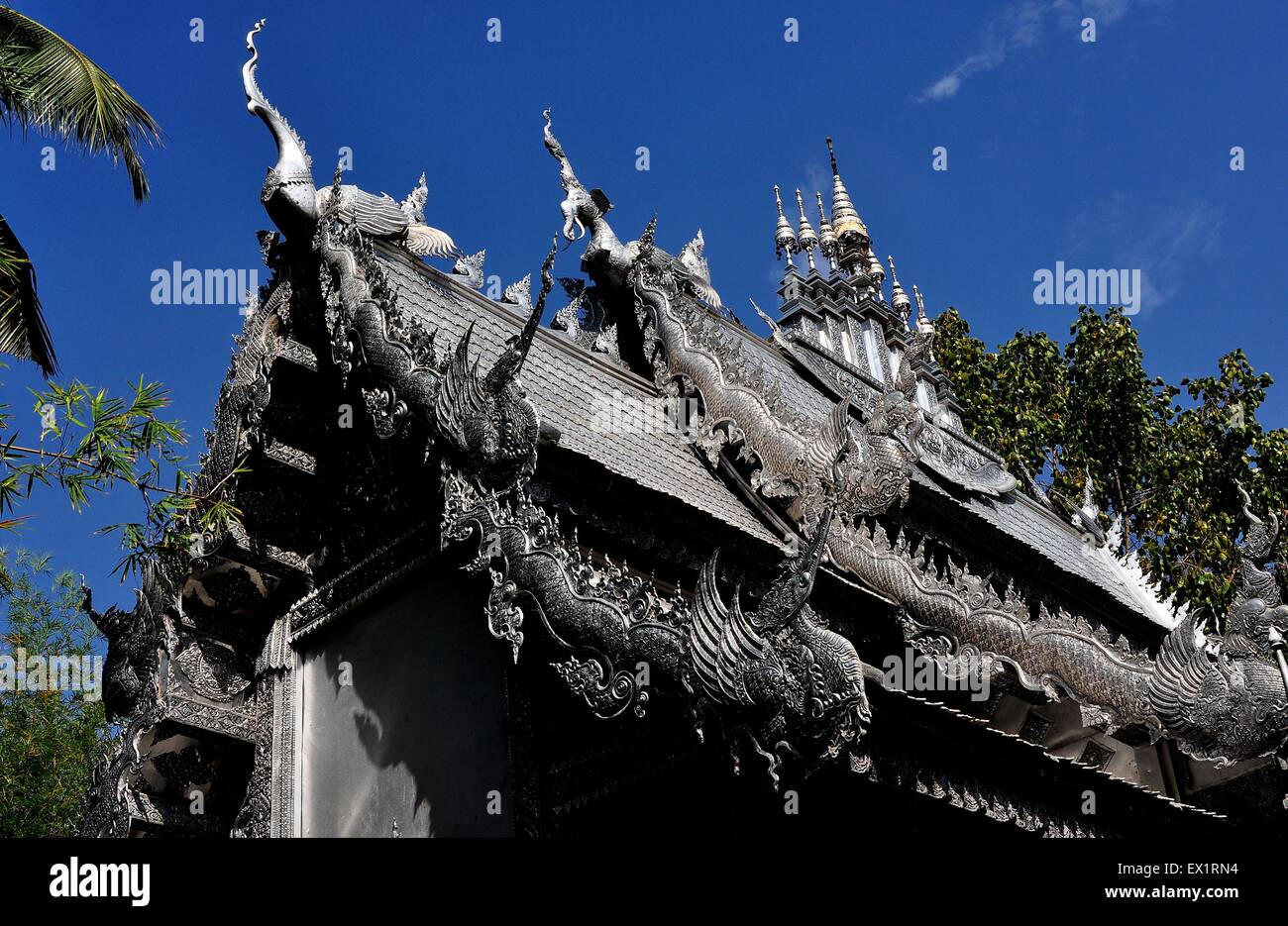 Chiang Mai, Thailand:  Silver dragons and chofahs decorate the Vihan's flamboyant roof at Wat Sri Suphan Stock Photo