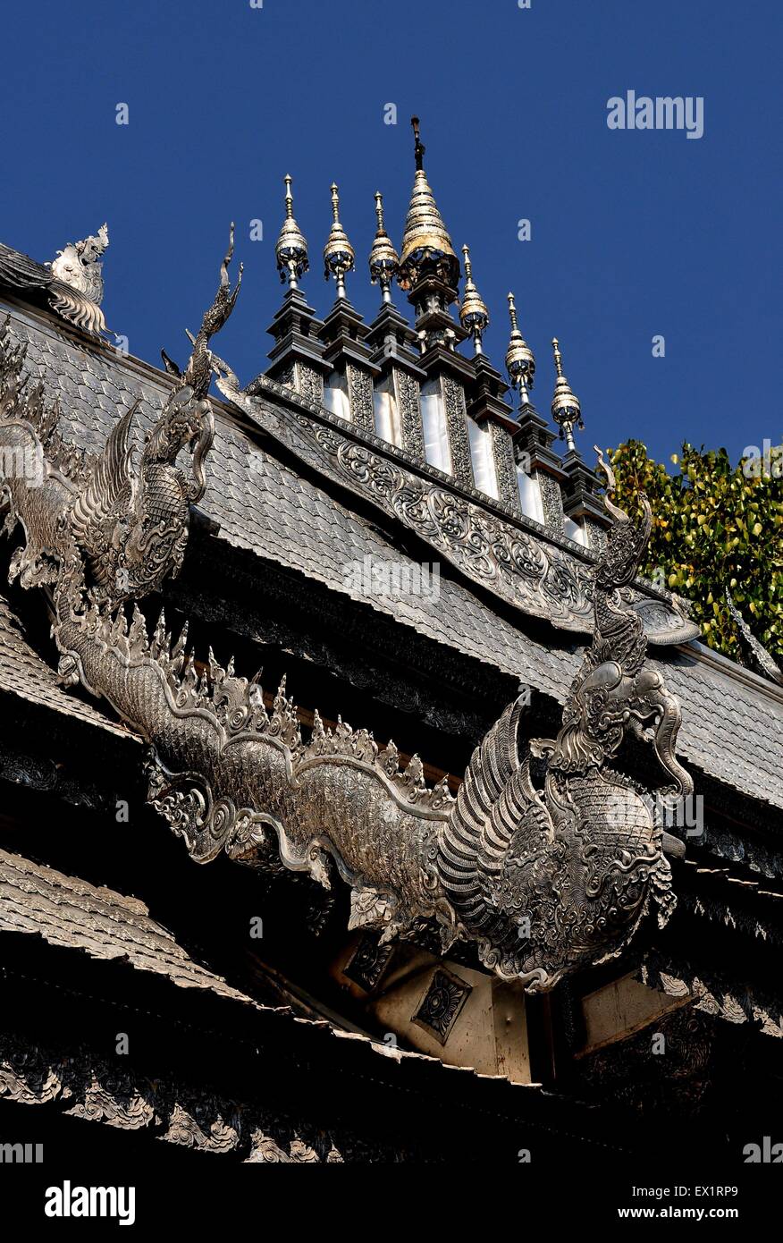 Chiang Mai, Thailand :  Silver dragons and seven finials decorate the Vihan's flamboyant roof at Wat Sri Suphan Stock Photo