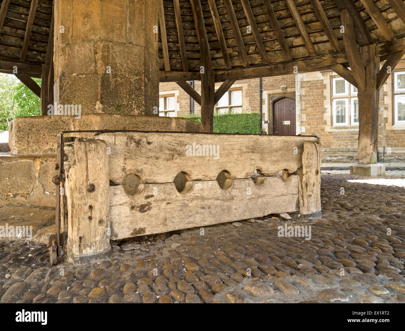 Medieval wooden stocks at the Old Butter Cross, Oakham, Rutland, England, UK. Stock Photo