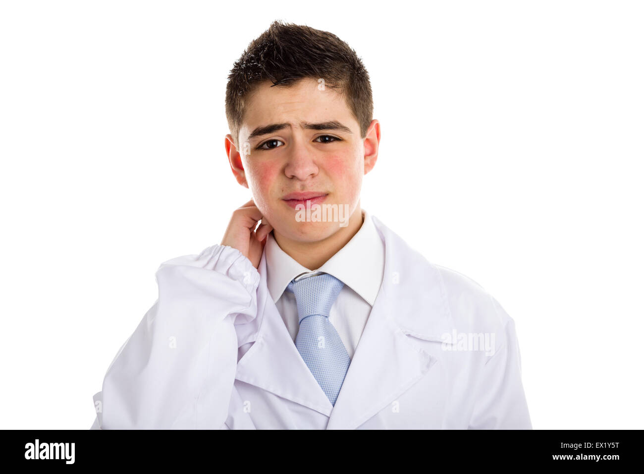 A boy doctor in white coat and blue tie helps to feel medicine more friendly: he is puzzled. His acne skin has not ben retouched Stock Photo