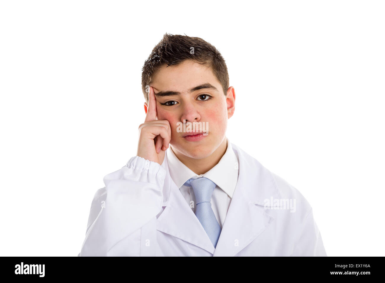 A boy doctor in white coat and blue tie helps to feel medicine more friendly: he is puzzled. His acne skin has not ben retouched Stock Photo