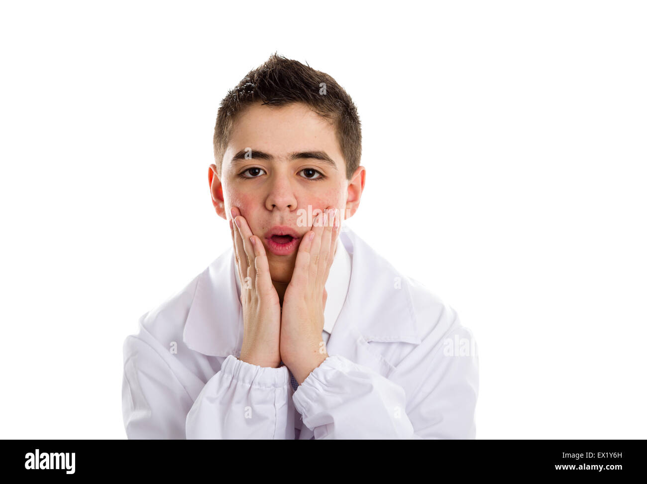 A boy doctor in white coat and blue tie helps to feel medicine more friendly: he is puzzled and holding his chin. His acne skin has not ben retouched Stock Photo