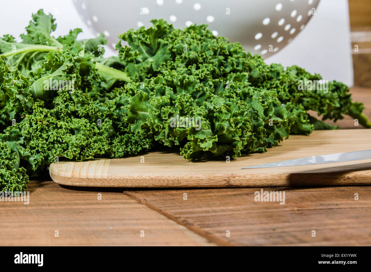Green curly kale and chef knife Stock Photo
