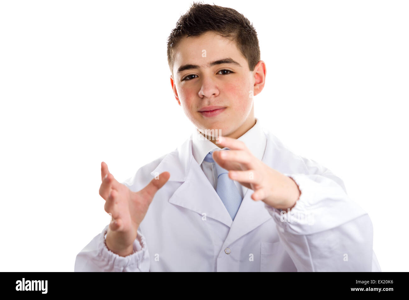 Boy dressed as a doctor in light blue tie and white coat helps to feel medicine more friendly: he making the gesture of moving hands as to reach viewers, catch something and drive to him. This means drive attention and give importance at the same time to Stock Photo