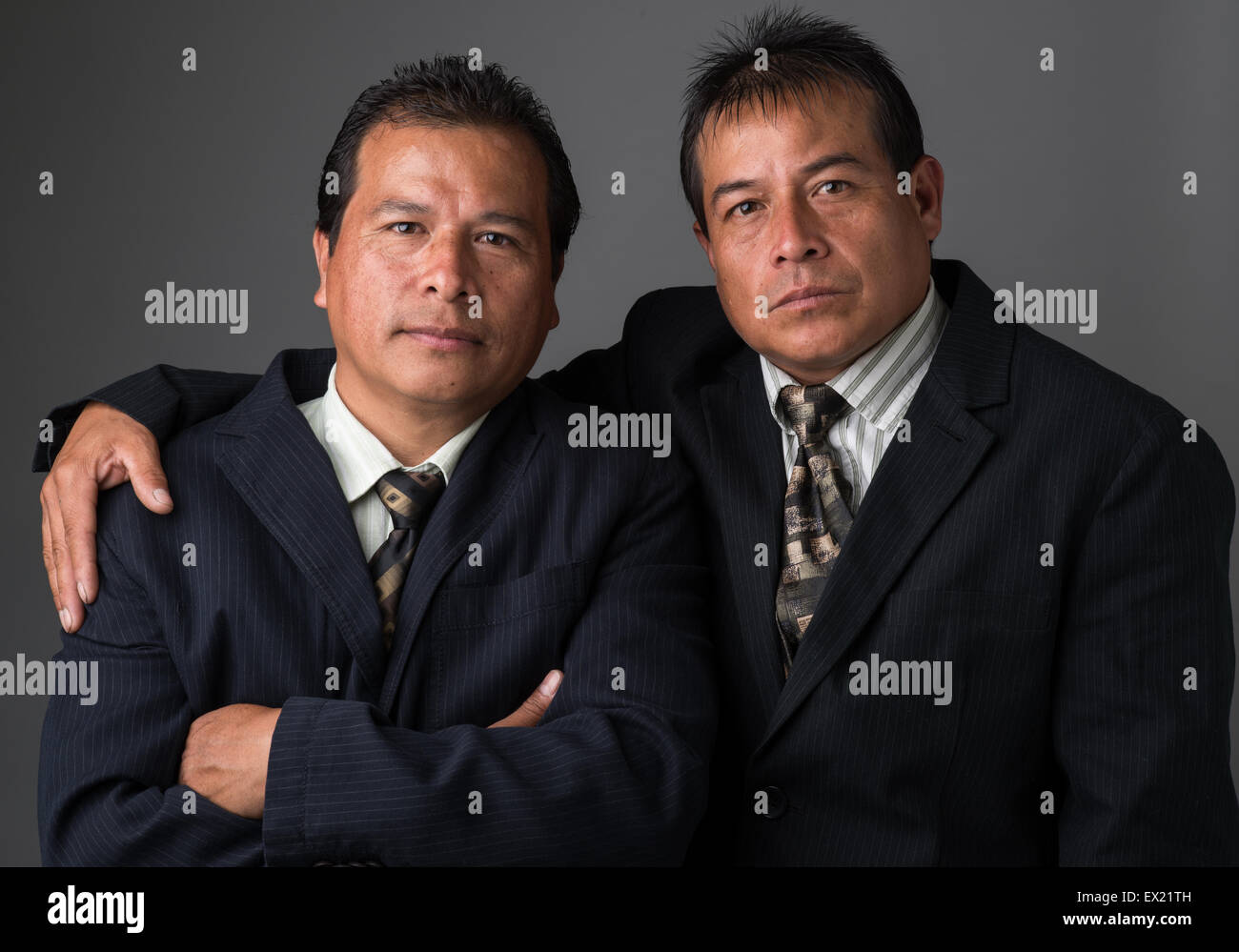 Hispanic business men wearing business suit and neckties posing for a portrait Stock Photo